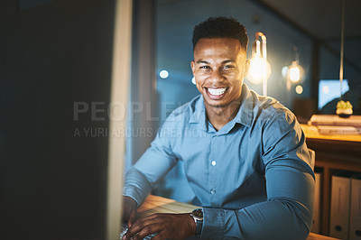 Buy stock photo Cropped portrait of a handsome young businessman working late at night in a modern office