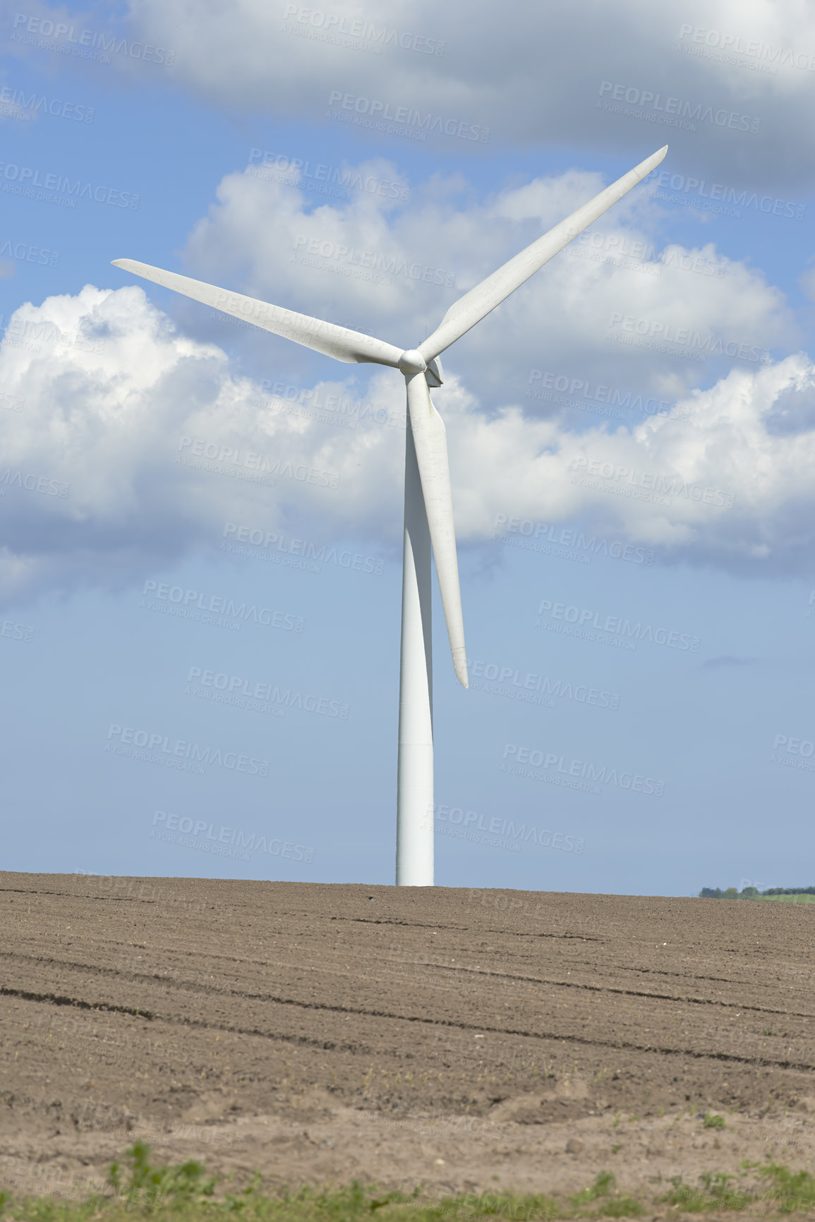 Buy stock photo Wind turbine generating alternative source of electricity and power. Conceptual nature scene for renewable energy. One modern windmill on a sandy hill outside against cloudy blue sky copy space. 