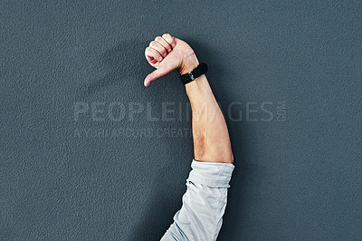 Buy stock photo Studio shot of an unrecognizable man raising his hand against a grey background