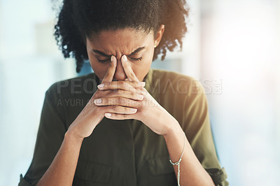 Buy stock photo Shot of a young businesswoman looking overly stressed in her office
