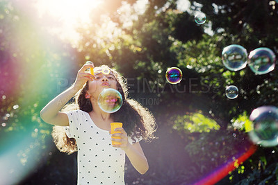 Buy stock photo Girl child, bubbles and backyard garden with mockup space in summer sunshine by trees for playing game. Female kid, blowing bubble and outdoor with soap, games and rainbow in nature, park and mock up