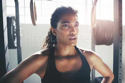 Buy stock photo Cropped shot of a focused young sportswoman gathering her thoughts at the gym