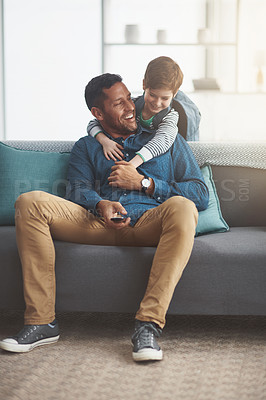 Buy stock photo Father, boy and hug for watching tv on sofa together in home, bonding and remote for channel. Daddy, son and family streaming in living room for movie, talk and embrace for security in relationship