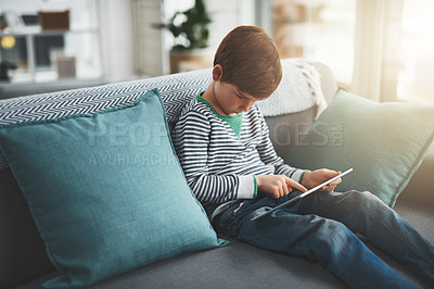 Buy stock photo Boy, games and kid on tablet in home for cartoon streaming online for movie, internet or video on technology. Notepad, house or male child on touchscreen for learning development or playing alone