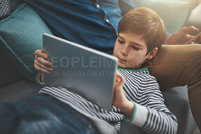 Buy stock photo Happy, tablet and parent with child on sofa for online streaming, playing games and internet. Family, home and dad with young boy on digital tech for watching movies, cartoons and videos for bonding