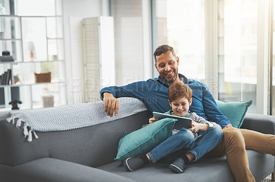 Buy stock photo Man, smile and son with tablet on sofa for online gaming, entertainment and streaming together. Family, home and child with tech by father for network, connection or bonding on weekend in living room