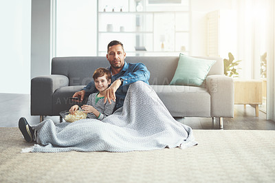 Buy stock photo Popcorn, portrait and father watching tv with child on floor in living room at family home. Blanket, bonding and dad with kid for streaming movie, film or show with snack in lounge at house in Canada