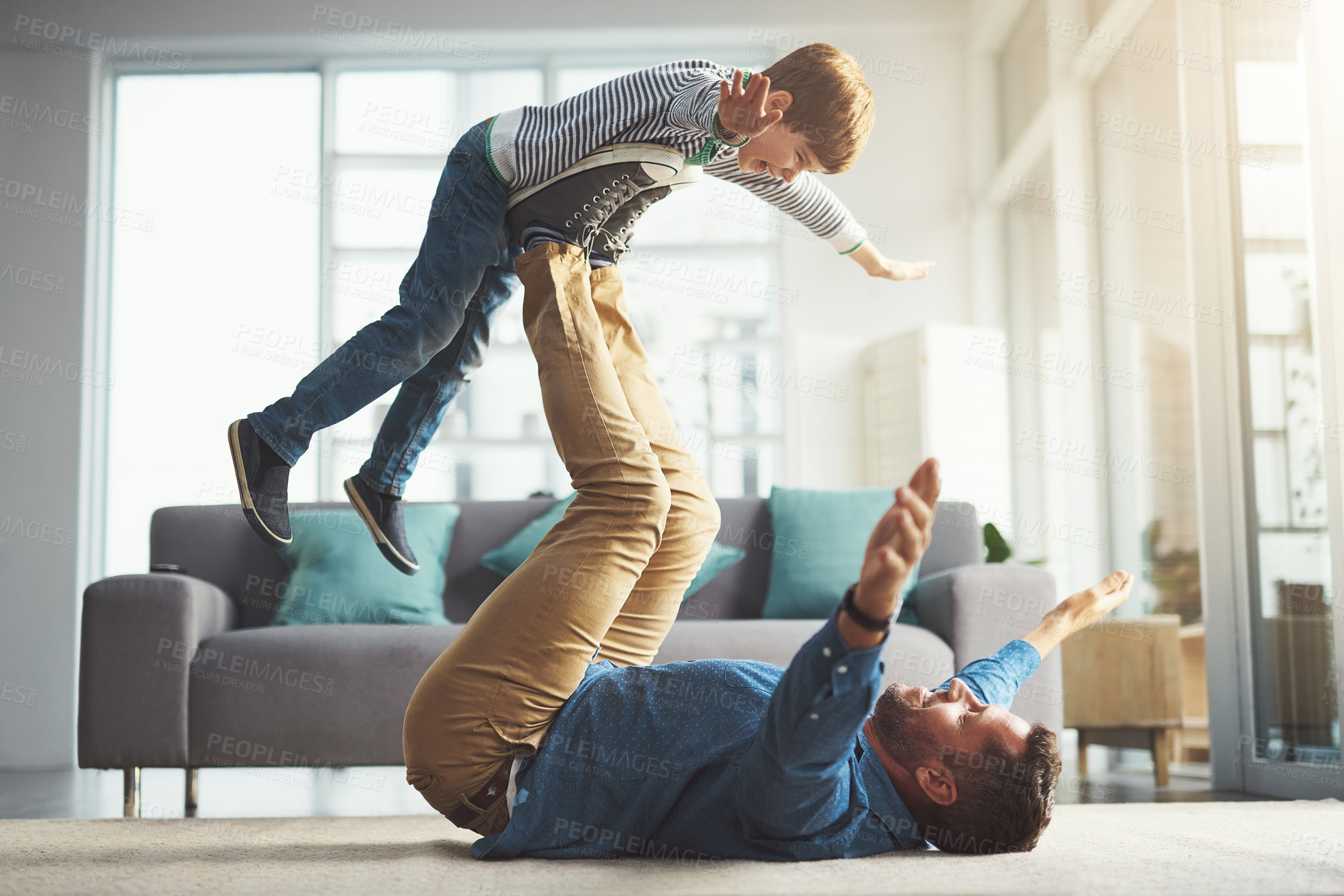 Buy stock photo Airplane, playing and dad with child in home for bonding, happy relationship and relax in living room. Family, playful and father with young boy having fun for flying, support and games on floor