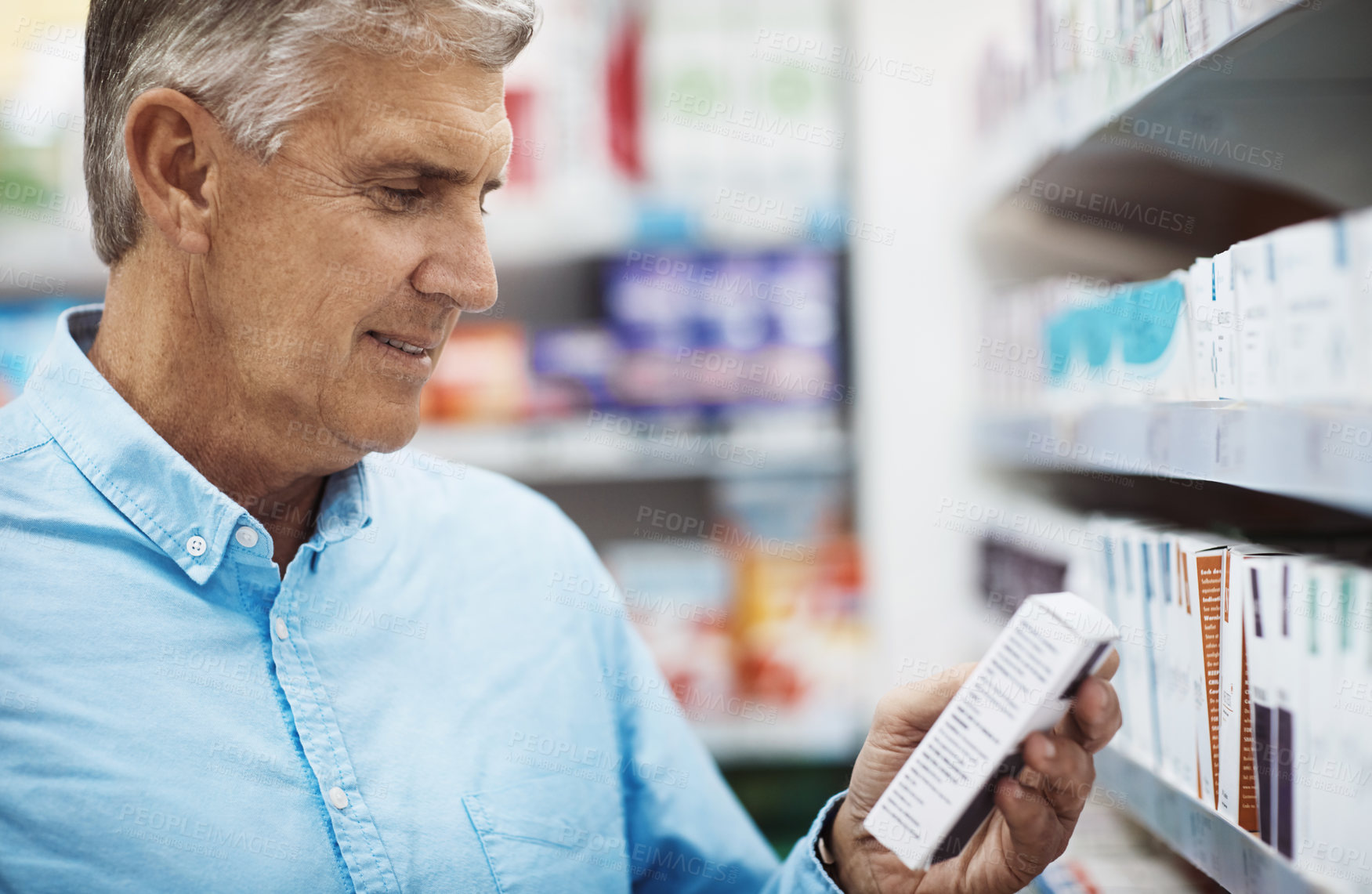 Buy stock photo Cropped shot of a customer browsing the shelves in a pharmacy