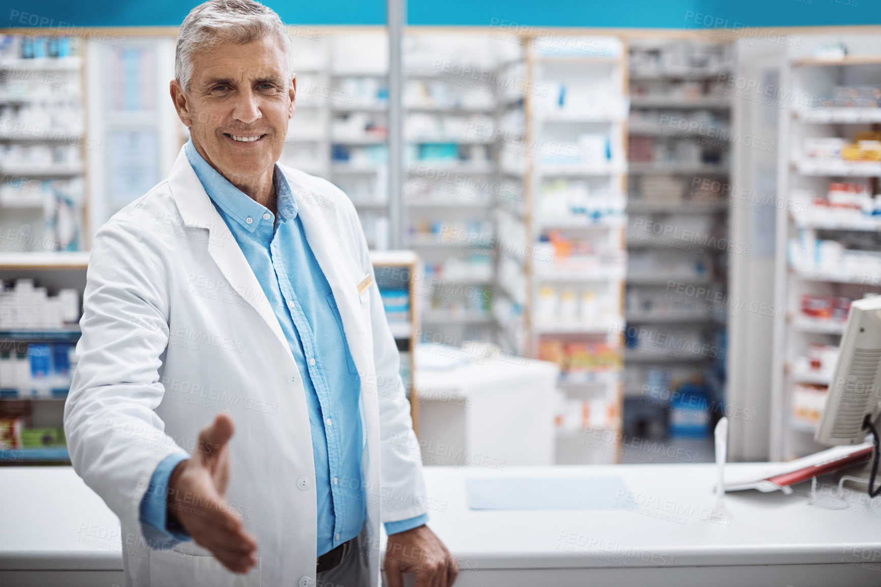 Buy stock photo Shot of a pharmacist extending his arm for a handshake