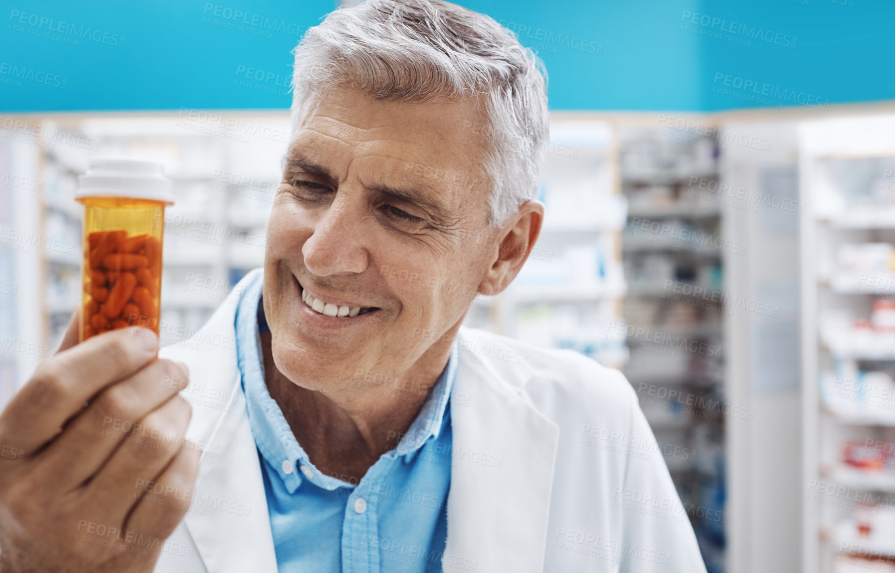 Buy stock photo Cropped shot of a pharmacist holding up capsules