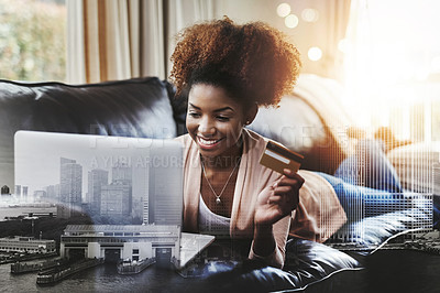 Buy stock photo Sho of an attractive young woman shopping online while chilling at home on the sofa