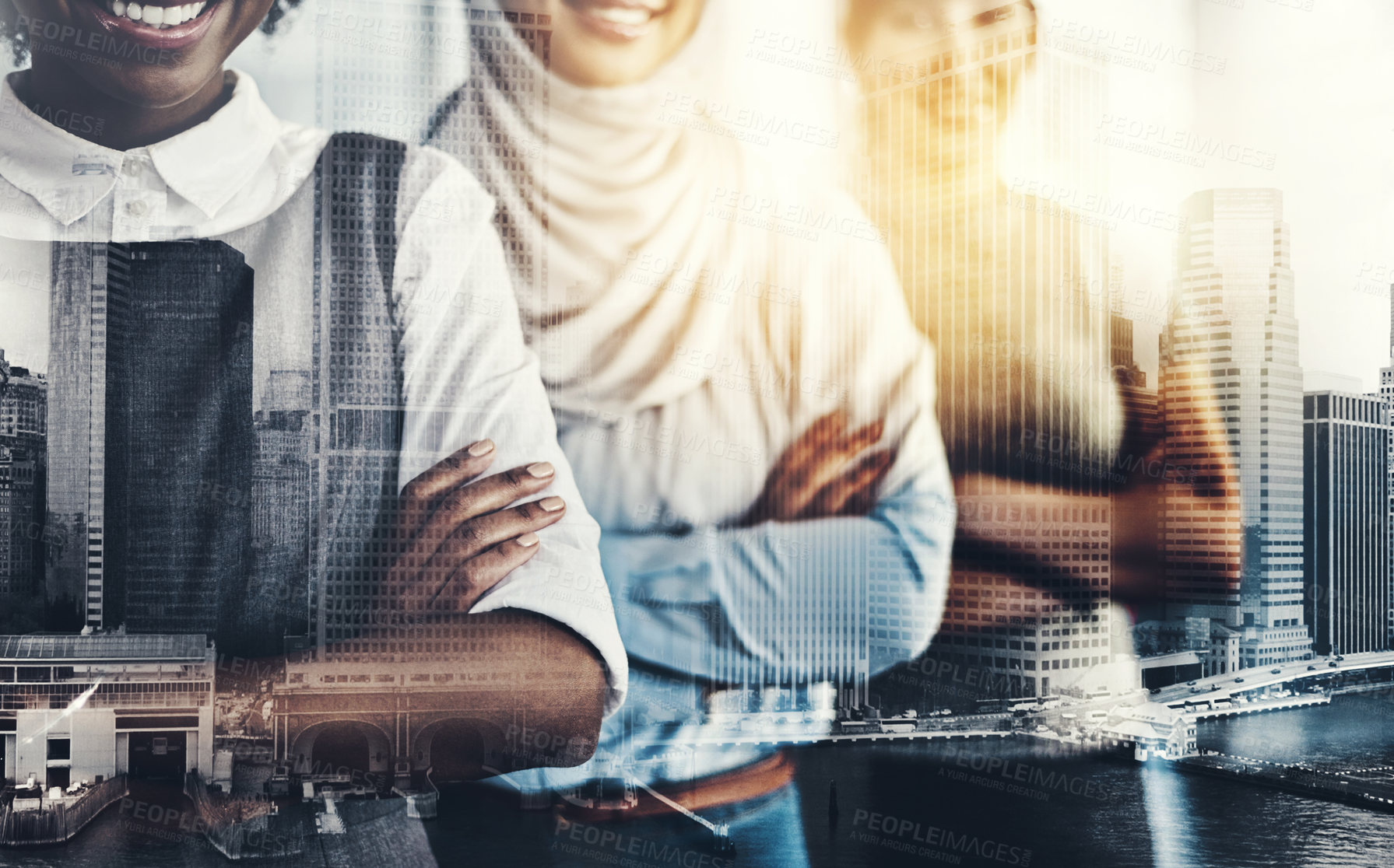 Buy stock photo Shot of a group of confident young businesswomen standing with their arms folded inside of the office at work