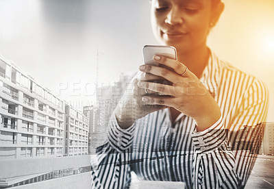 Buy stock photo Shot of a young businesswoman using a cellphone in an office