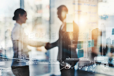 Buy stock photo Defocused shot of two businesspeople shaking hands in an office