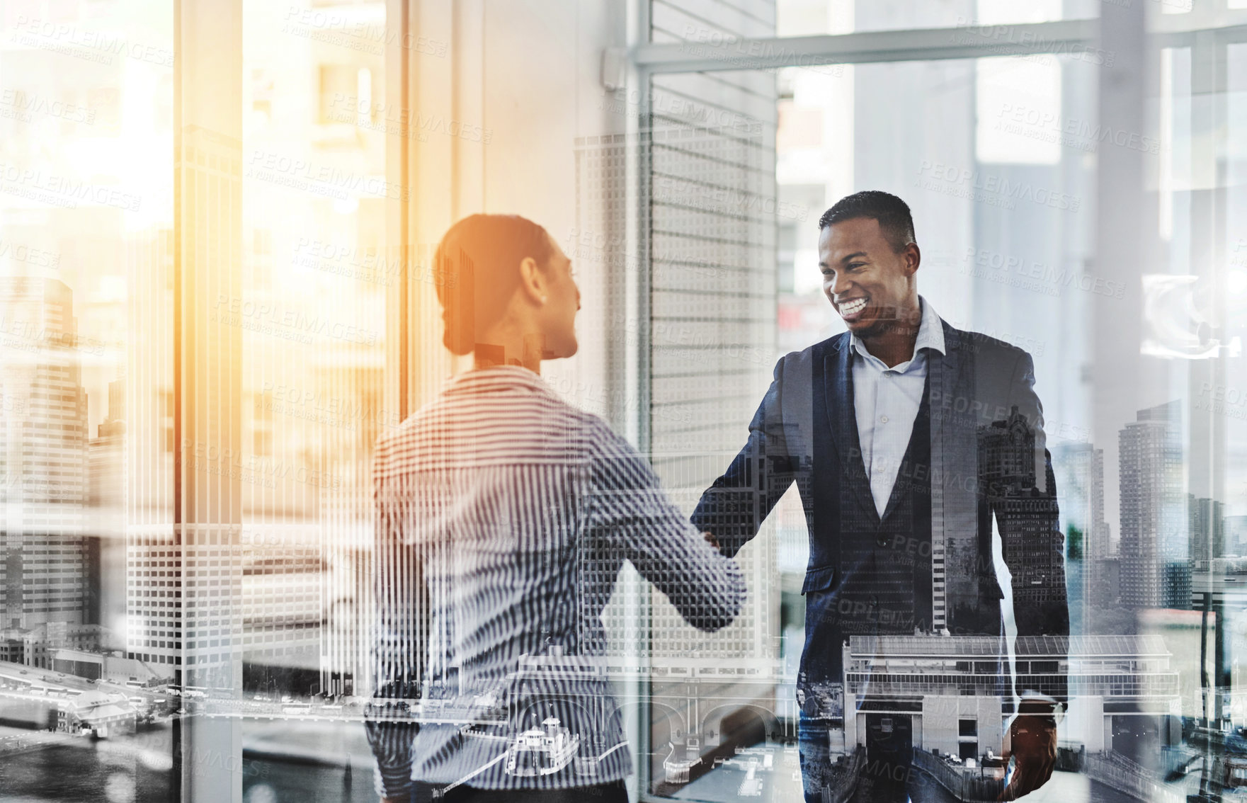 Buy stock photo Shot of two businesspeople shaking hands in an office