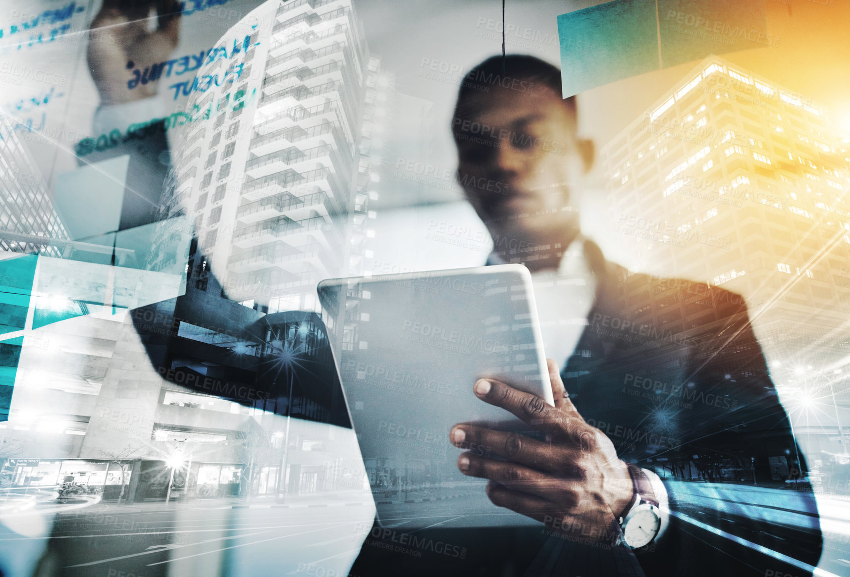 Buy stock photo Shot of a young businessman using a digital tablet while writing notes on a glass wall in an office