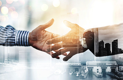 Buy stock photo Closeup shot of two unrecognizable businesspeople shaking hands in an office