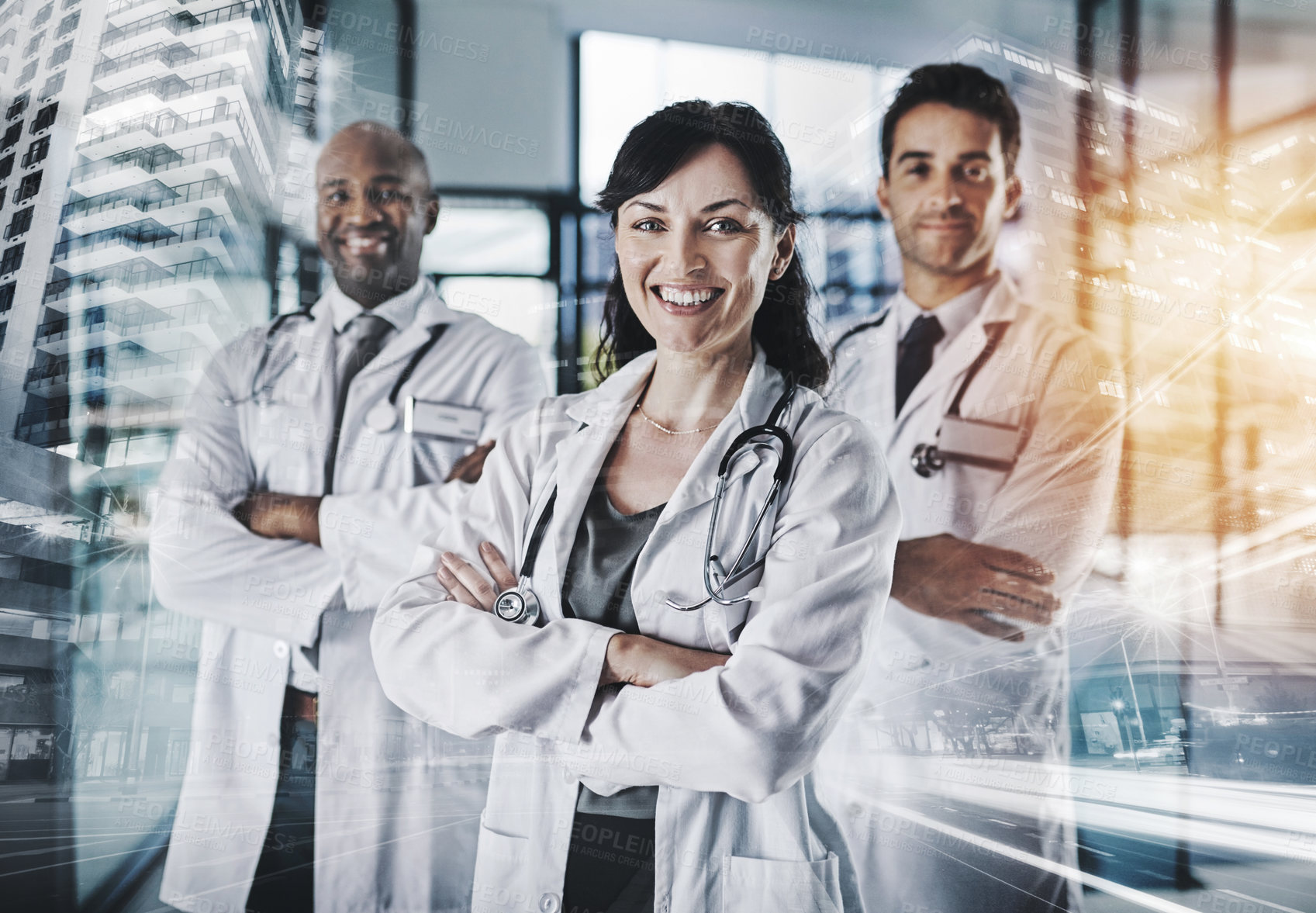 Buy stock photo Cropped portrait of a team of confident doctors standing with their arms crossed in a hospital