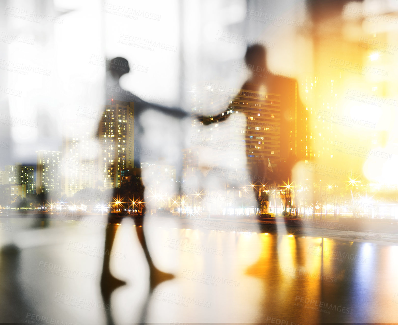 Buy stock photo Defocused shot of two unrecognizable businesspeople shaking hands in an office