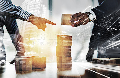 Buy stock photo Cropped shot of two unrecognizable businesspeople stacking wooden blocks together in an office