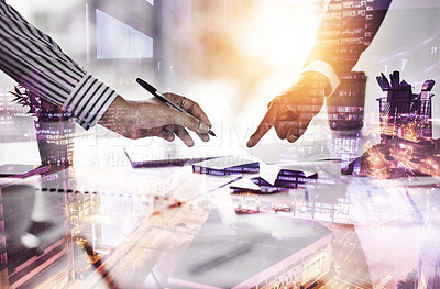 Buy stock photo Closeup shot of two businesspeople going through paperwork in an office