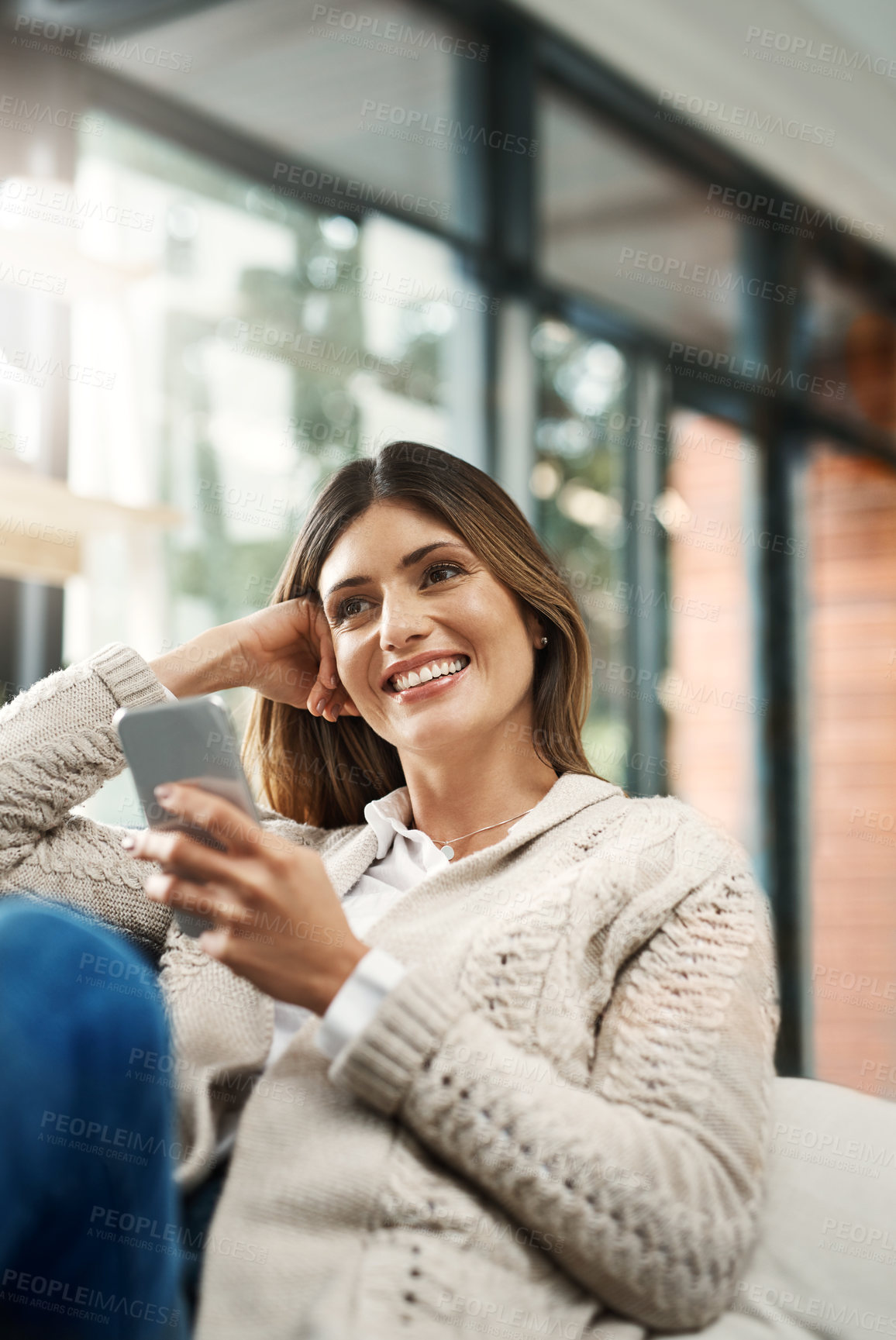 Buy stock photo Happy woman, relax and thinking with phone for social media, communication or browsing at home. Female person with smile on mobile smartphone for online chatting, texting or app on living room sofa