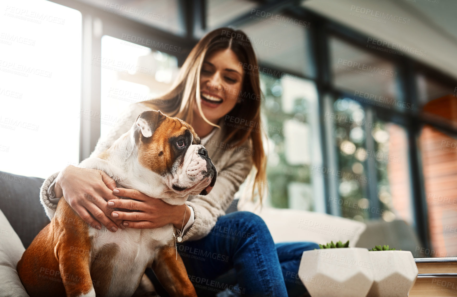Buy stock photo Woman, dog and hug on sofa in home for happy connection with best friend relaxing, bonding or living room. Female person, bulldog and animal pet as emotional support with loving, care or laughing
