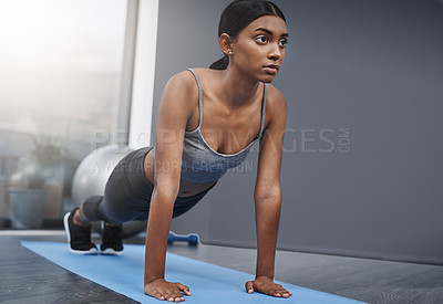 Buy stock photo Push ups, fitness and woman in the gym training, exercise or workout for commitment to health and wellness. Yoga, serious and healthy female person start stretching body for morning sport performance