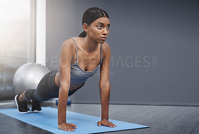 Buy stock photo Stretching, training and woman in the gym for fitness, exercise or workout for commitment to health and wellness. Yoga, serious and healthy young female person ready morning sport performance