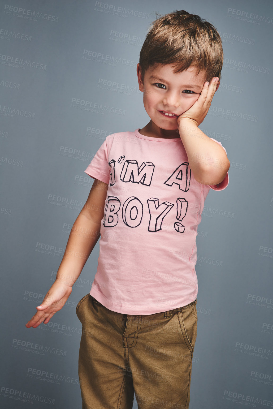 Buy stock photo Fashion, text and portrait of boy in studio with trendy style, casual clothes and cool t shirt. Happy, smile and isolated kid with quote for gender identity, choice and pride on gray background