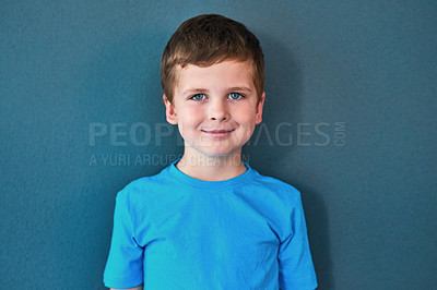 Buy stock photo Boy, child and portrait with smile in studio, happiness for education in New York City. Male student, elementary grade and cheerful for knowledge in classroom, back to school on blue background