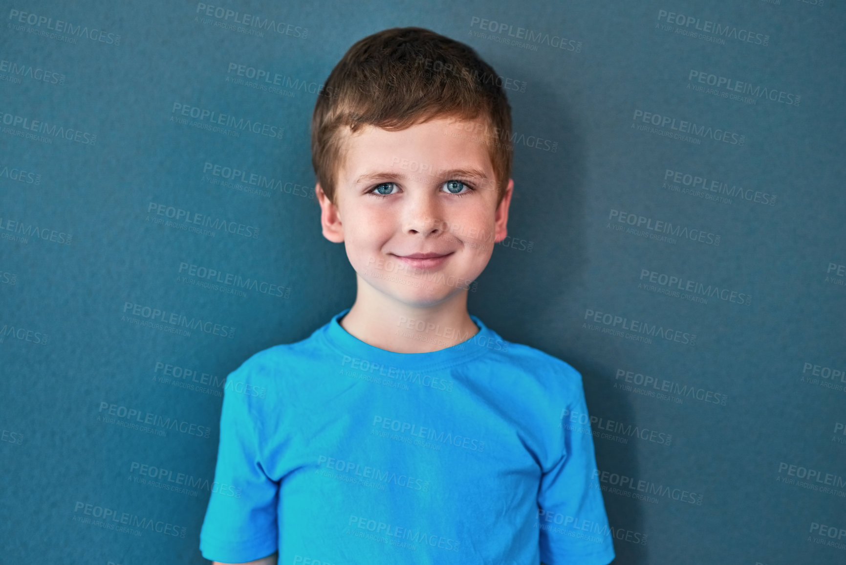 Buy stock photo Boy, child and portrait with smile in studio, happiness for education in New York City. Male student, elementary grade and cheerful for knowledge in classroom, back to school on blue background