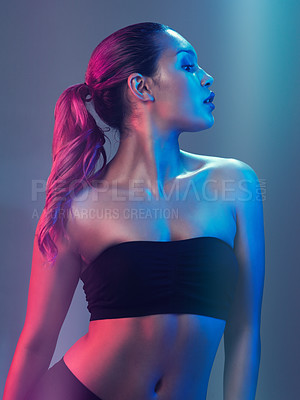 Buy stock photo Studio shot of a beautiful young woman posing against a multi colored background