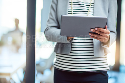 Buy stock photo Cropped shot of an unrecognizable businesswoman using a tablet in the workplace