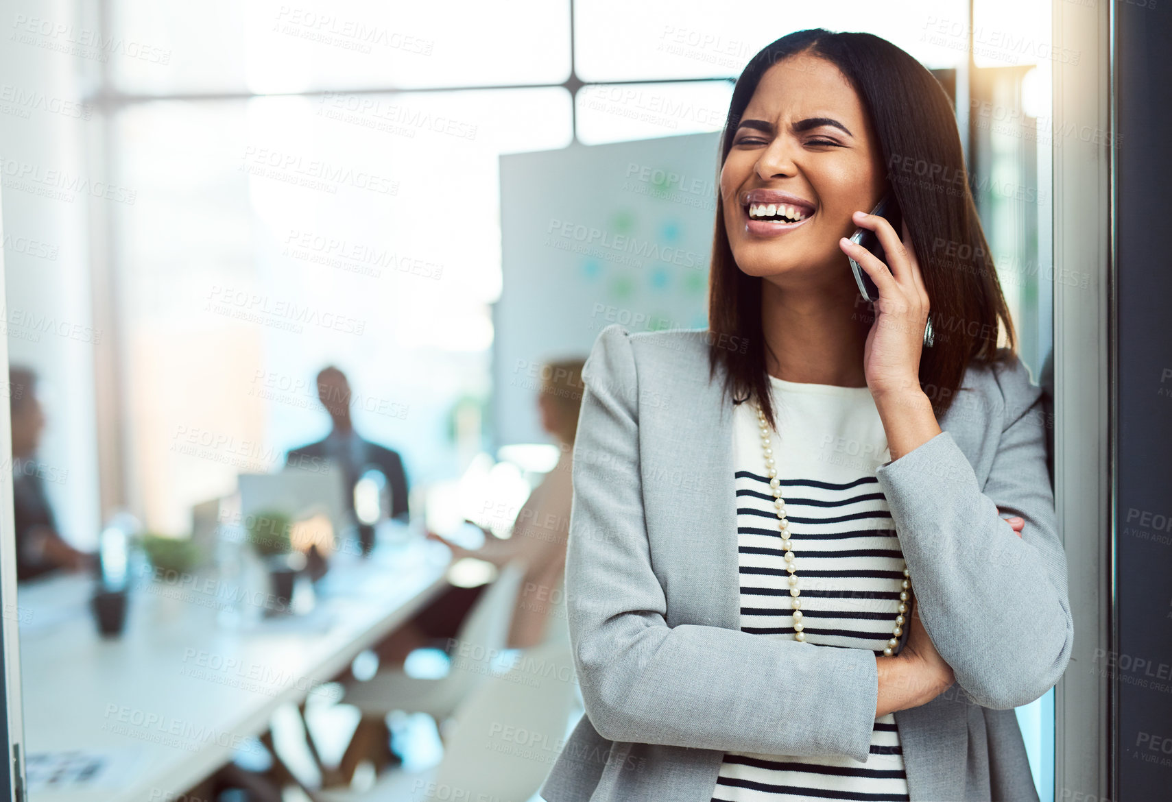 Buy stock photo Cropped shot of a beautiful young businesswoman on a call in the workplace