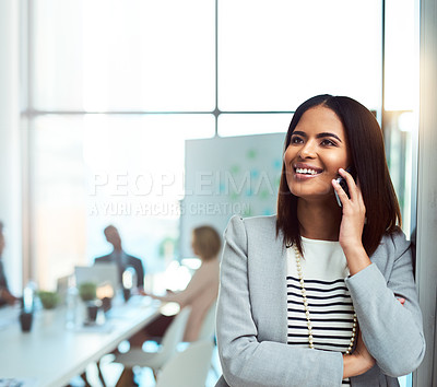 Buy stock photo Cropped shot of a beautiful young businesswoman on a call in the workplace