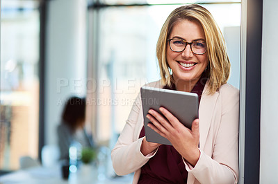 Buy stock photo Cropped shot of a beautiful young businesswoman using a tablet in the workplace