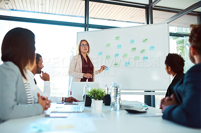 Buy stock photo Shot of corporate businesspeople having a meeting in the boardroom at work