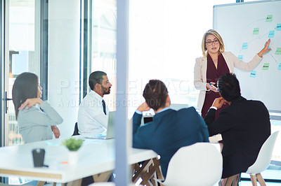 Buy stock photo Shot of corporate businesspeople having a meeting in the boardroom at work