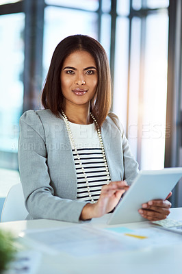 Buy stock photo Portrait of a beautiful young corporate businesswoman using a tablet in the workplace