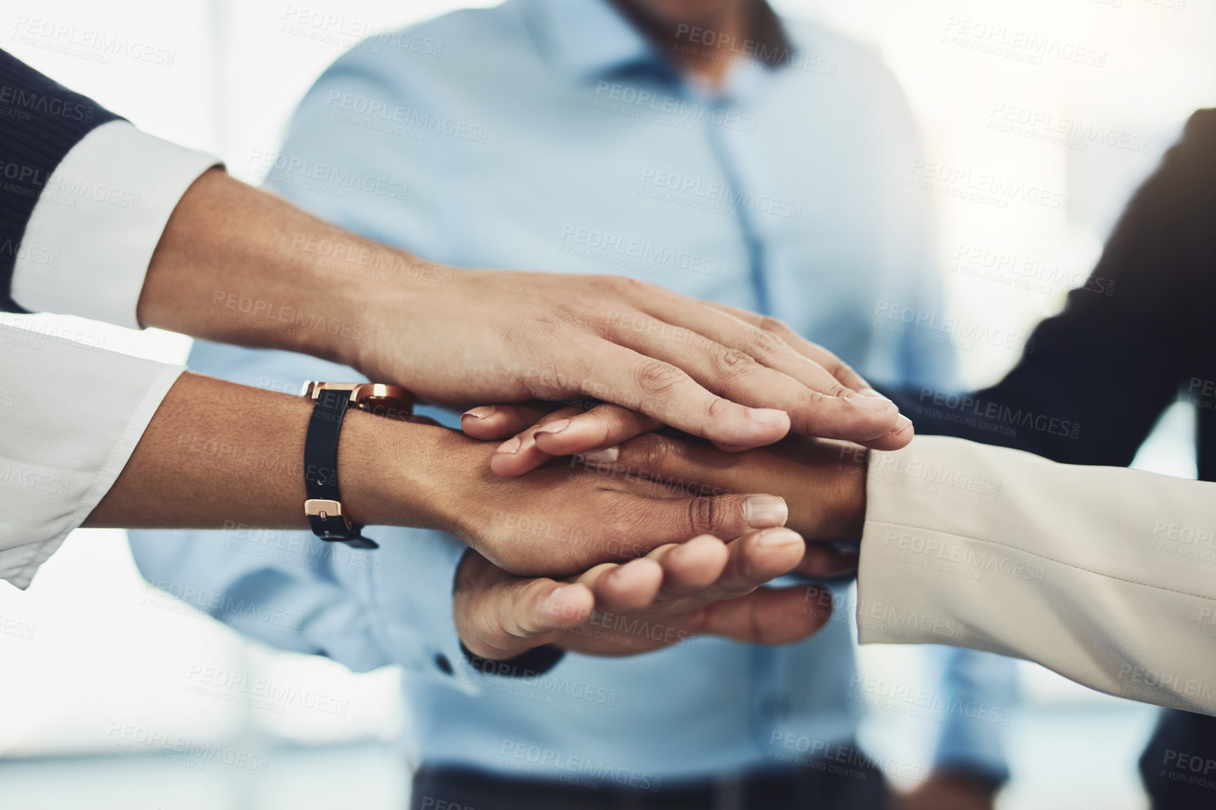 Buy stock photo Closeup of a group of unrecognizable businesspeople forming a huddle with their hands inside of the office during the day