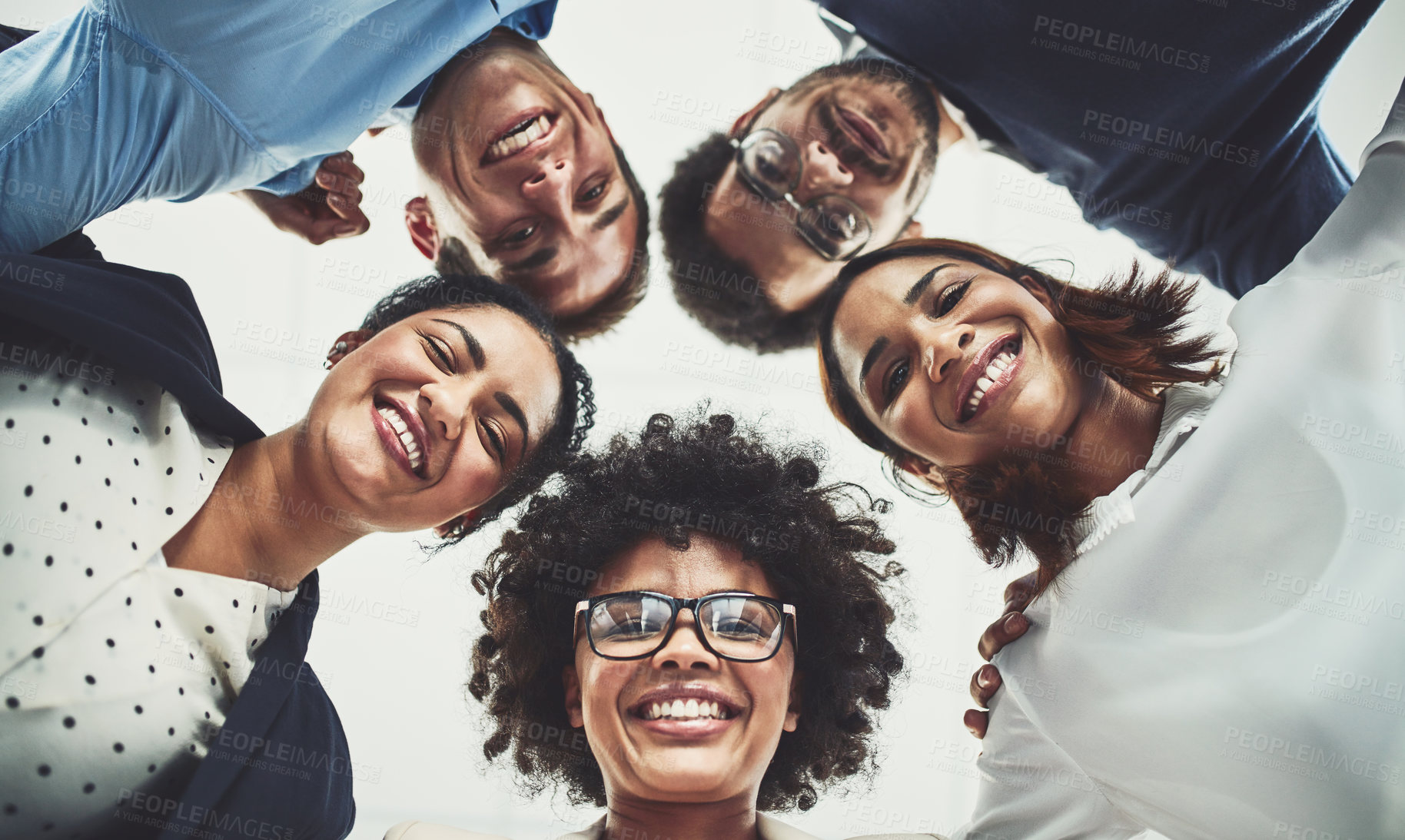 Buy stock photo Low angle shot of a group of cheerful businesspeople looking down at the camera in the office during the day