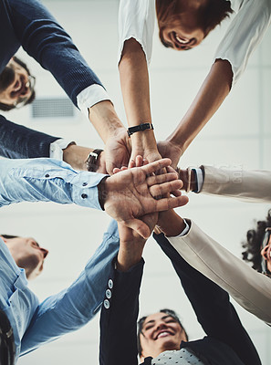 Buy stock photo Teamwork, collaboration and unity between business people with their hands stacked for project development and innovation. Group of corporate colleagues united, joining or working together from below