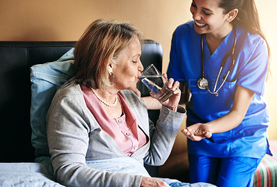 Buy stock photo Cropped shot of a nurse giving medication and a glass of water to a patient