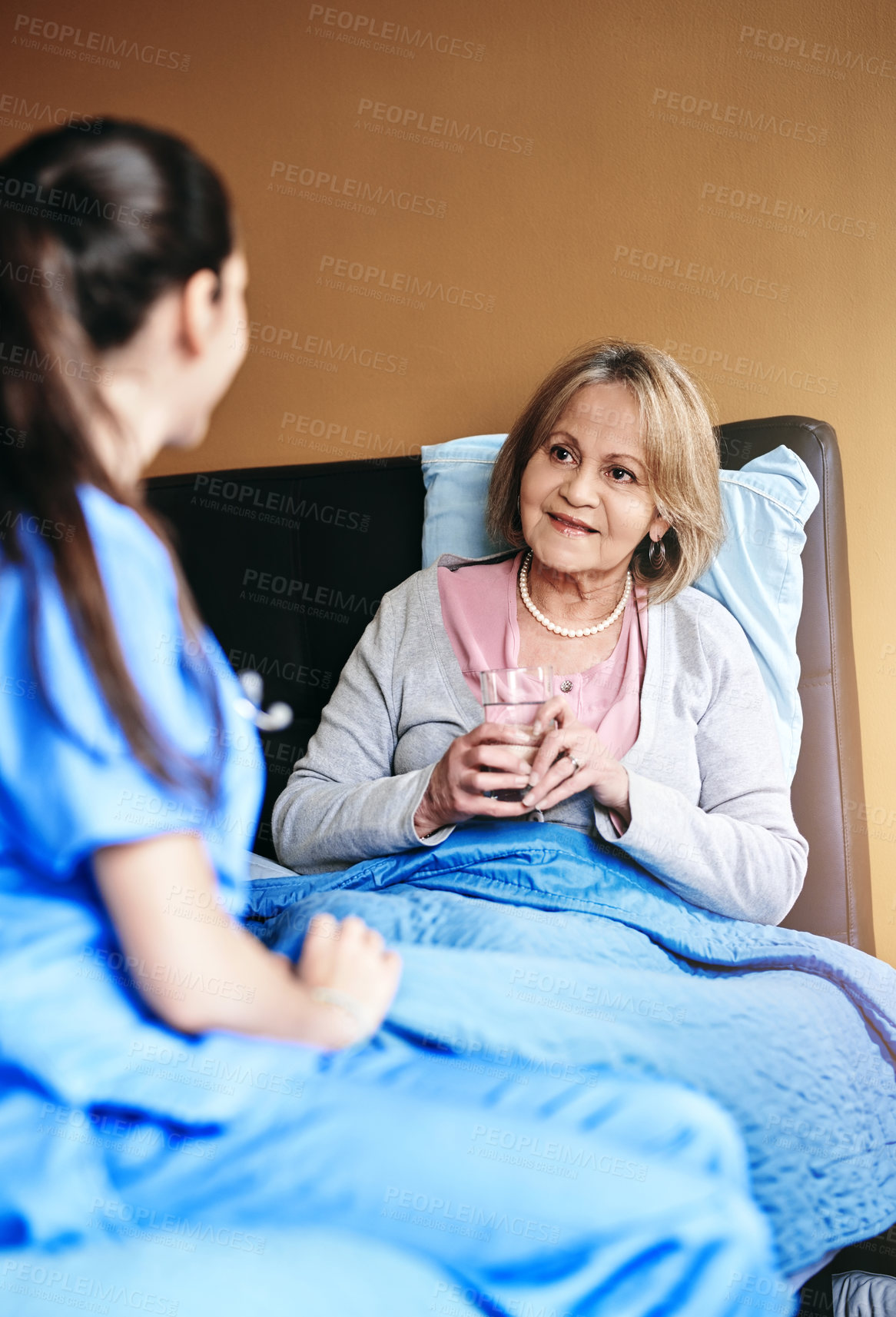 Buy stock photo Elderly, woman and nurse with drinking medication at retirement facility for healthcare and prescription drugs. Senior, patient or caregiver in nursing home with pills, support and water for wellness