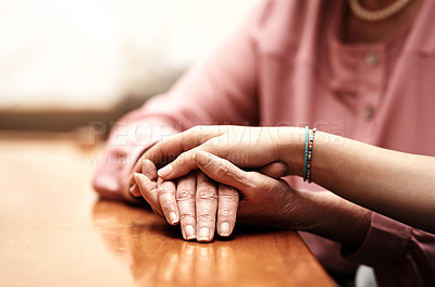 Buy stock photo Empathy, love and hands of people on table for support, compassion and solidarity in hope together. Home, trust and women with gesture of kindness on desk for comfort, forgiveness and understanding