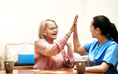 Buy stock photo Cropped shot of a senior woman playing cards with her caregiver