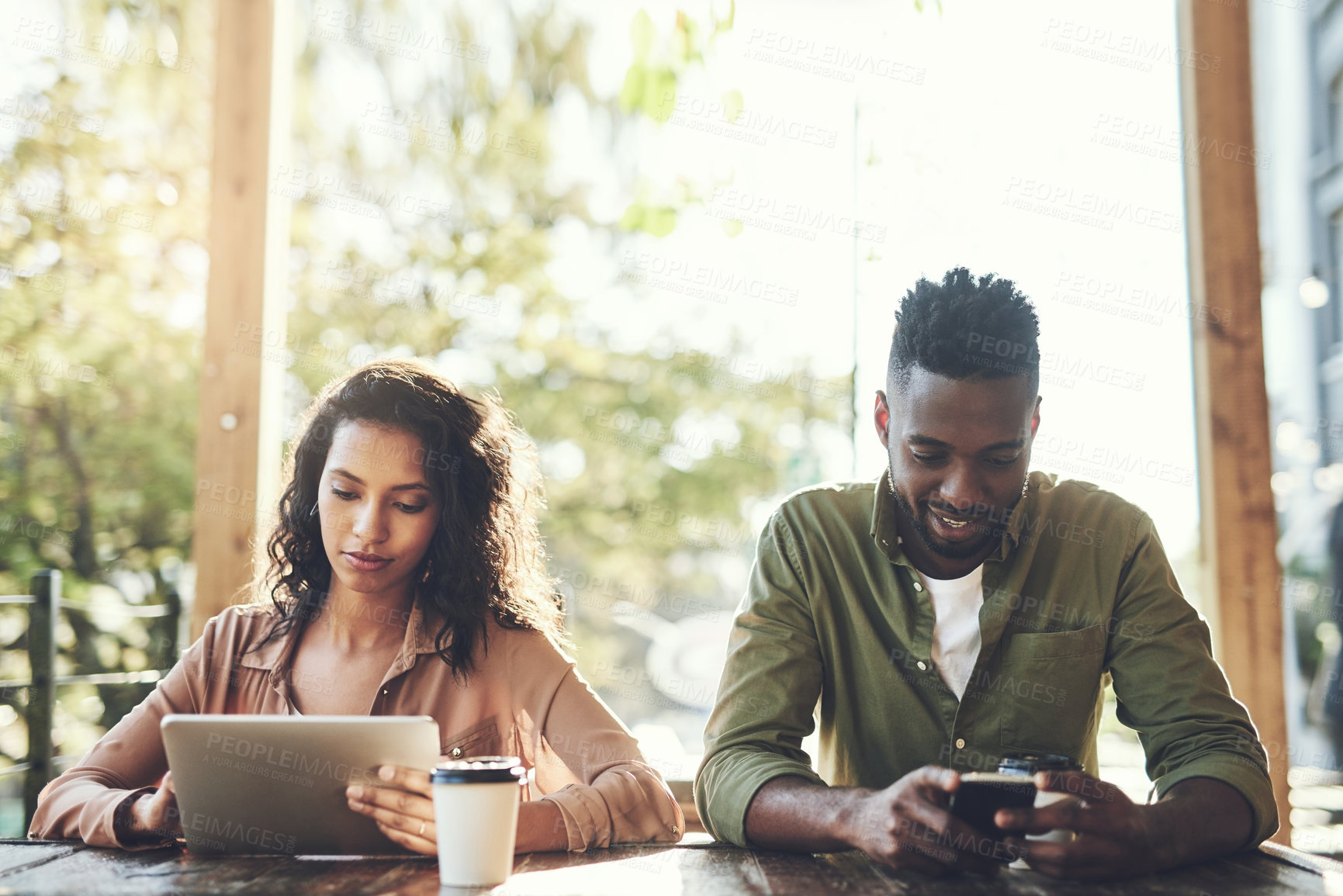 Buy stock photo African, couple and technology with coffee at cafe for morning breakfast, social media and communication. People, tablet and cellphone for browsing website, typing email and restaurant bonding