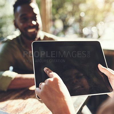 Buy stock photo Shot of a young man placing his order with a waiter using a digital tablet